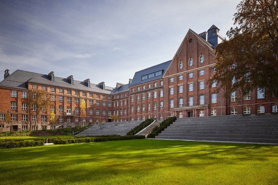 Campus view of Technical University of Dresden showing modern academic buildings, student facilities, and a vibrant university environment.