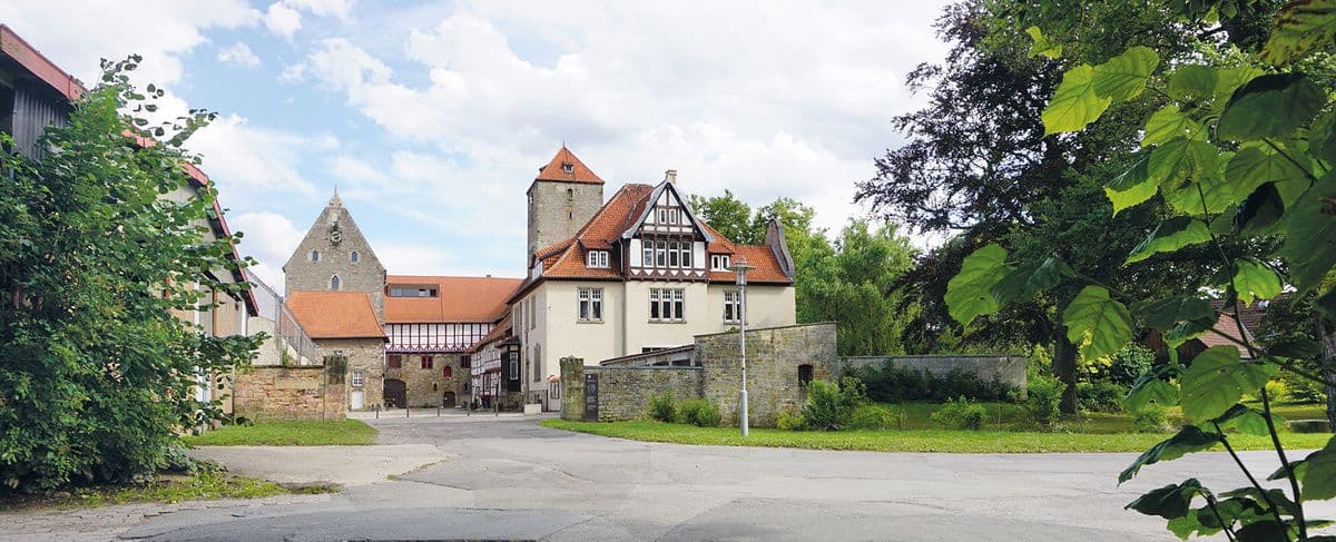 Main campus of University of Hildesheim in Germany, featuring modern academic buildings and students on campus.